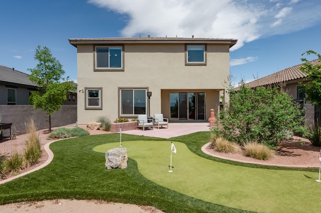 1608 Mammoth Way, Albuquerque, NM 87120 - back of house with an area to practice putting, a patio area, and stucco siding