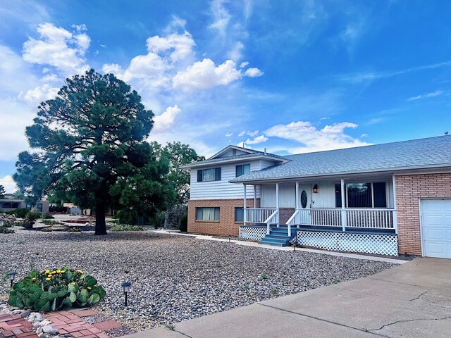 10008 Greene Ave NW, Albuquerque, NM 87114 - view of property exterior with an attached garage and brick siding