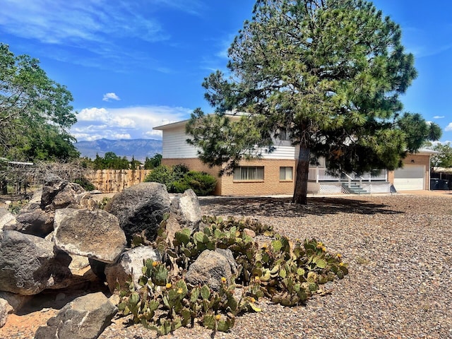 10008 Greene Ave NW, Albuquerque, NM 87114 - view of property exterior with an attached garage and brick siding