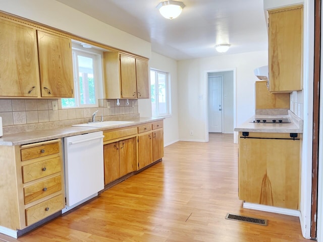 10008 Greene Ave NW, Albuquerque, NM 87114 - kitchen featuring dishwasher, light wood-type flooring, a sink, and light countertops