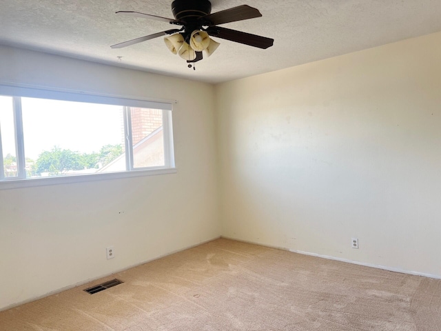 10008 Greene Ave NW, Albuquerque, NM 87114 - spare room with light carpet, ceiling fan, and a textured ceiling