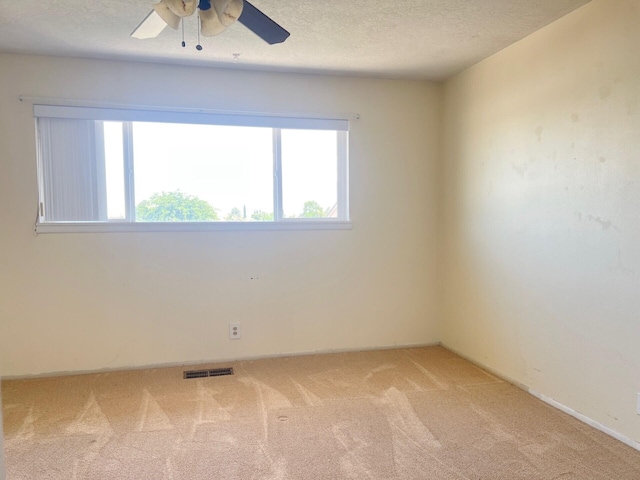 10008 Greene Ave NW, Albuquerque, NM 87114 - unfurnished room featuring light colored carpet, ceiling fan, a textured ceiling, and baseboards