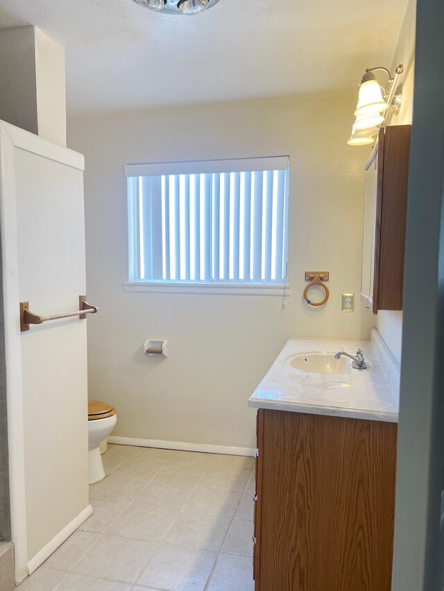 10008 Greene Ave NW, Albuquerque, NM 87114 - full bath with vanity, toilet, tile patterned flooring, and baseboards