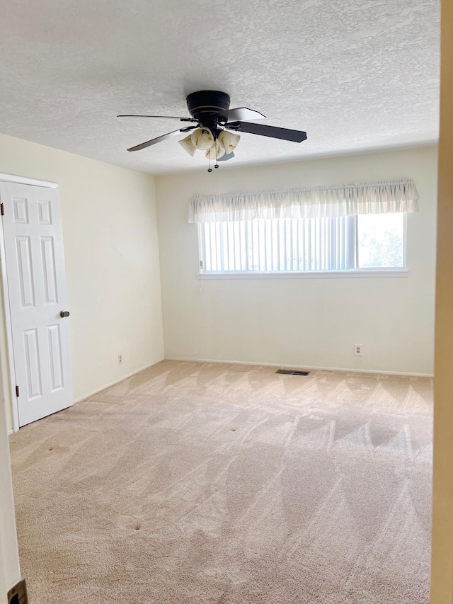 10008 Greene Ave NW, Albuquerque, NM 87114 - spare room with carpet, a ceiling fan, and a textured ceiling