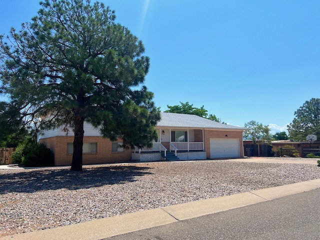 10008 Greene Ave NW, Albuquerque, NM 87114 - ranch-style home featuring a porch, brick siding, a garage, and driveway