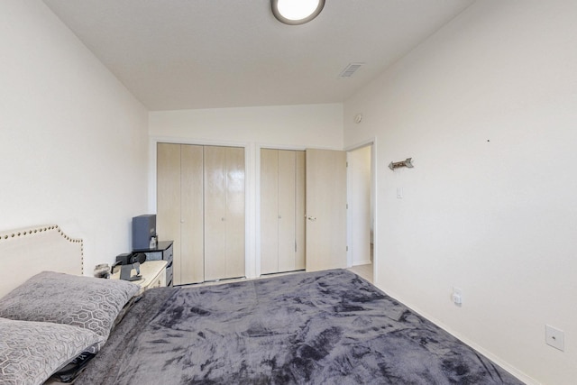 1128 Pandora Dr SW, Los Lunas, NM 87031 - bedroom featuring multiple closets, lofted ceiling, baseboards, and carpet flooring