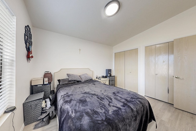 1128 Pandora Dr SW, Los Lunas, NM 87031 - bedroom featuring light wood-type flooring, two closets, and vaulted ceiling