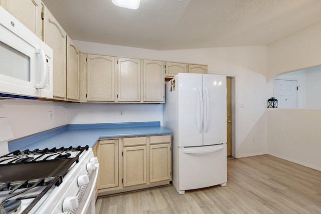 1128 Pandora Dr SW, Los Lunas, NM 87031 - kitchen with white appliances, light wood-style flooring, light countertops, baseboards, and vaulted ceiling