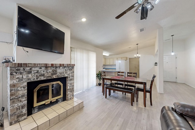 1128 Pandora Dr SW, Los Lunas, NM 87031 - living room featuring a fireplace, a ceiling fan, light wood-type flooring, vaulted ceiling, and recessed lighting
