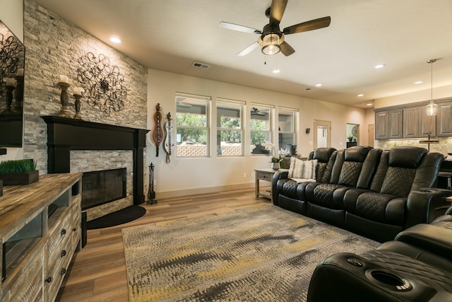 31 Express Blvd, Sandia Park, NM 87047 - living area with a ceiling fan, wood finished floors, baseboards, a fireplace, and recessed lighting