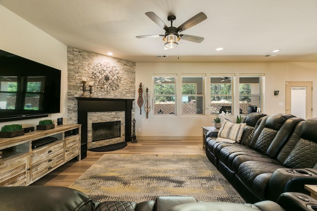 31 Express Blvd, Sandia Park, NM 87047 - living room with ceiling fan, a stone fireplace, wood finished floors, recessed lighting, and baseboards