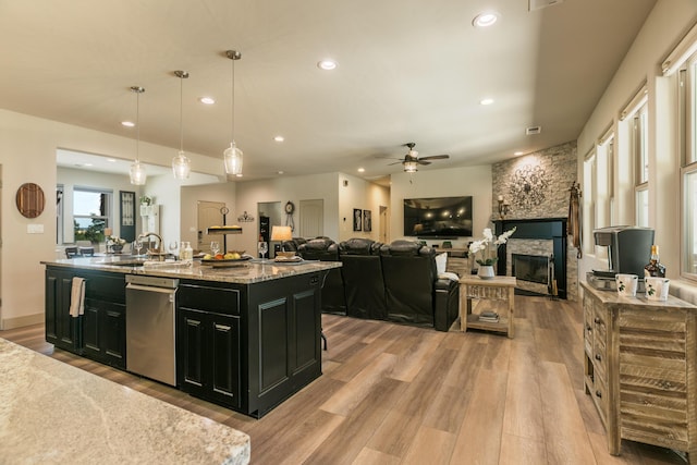 31 Express Blvd, Sandia Park, NM 87047 - kitchen featuring dark cabinets, dishwasher, a sink, light wood-style flooring, and a ceiling fan