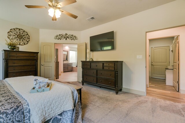 31 Express Blvd, Sandia Park, NM 87047 - bedroom with light colored carpet, baseboards, ensuite bathroom, and a ceiling fan