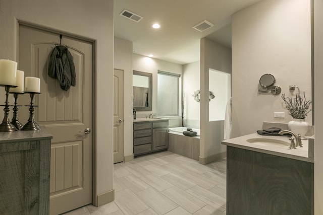 31 Express Blvd, Sandia Park, NM 87047 - full bath featuring two vanities, a garden tub, baseboards, and recessed lighting
