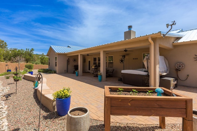 31 Express Blvd, Sandia Park, NM 87047 - back of property with a hot tub, ceiling fan, a patio, and metal roof