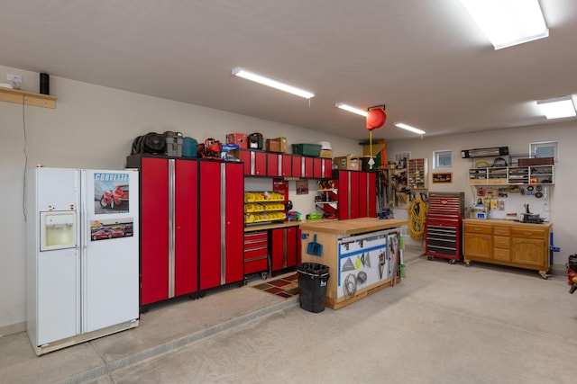 31 Express Blvd, Sandia Park, NM 87047 - garage featuring white fridge with ice dispenser and a workshop area