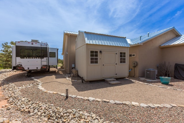 31 Express Blvd, Sandia Park, NM 87047 - rear view of property featuring metal roof, central AC unit, and a standing seam roof
