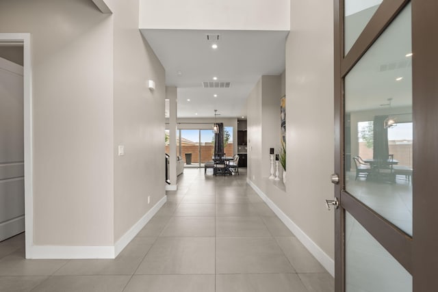 6527 Trestle Glen Rd NW, Albuquerque, NM 87120 - corridor with baseboards and light tile patterned floors