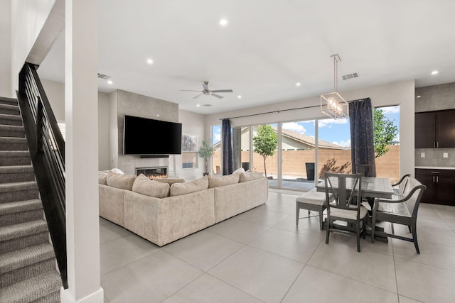 6527 Trestle Glen Rd NW, Albuquerque, NM 87120 - living room featuring stairs, healthy amount of natural light, a ceiling fan, light tile patterned floors, and recessed lighting
