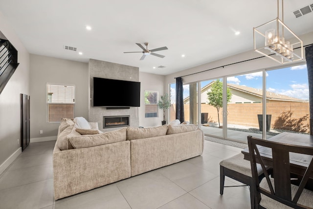 6527 Trestle Glen Rd NW, Albuquerque, NM 87120 - living area with a fireplace, recessed lighting, ceiling fan, baseboards, and a chandelier