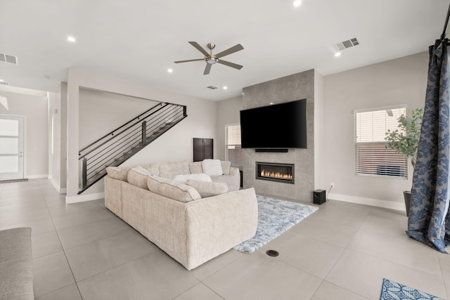 6527 Trestle Glen Rd NW, Albuquerque, NM 87120 - tiled living area featuring stairway, ceiling fan, a tiled fireplace, and recessed lighting