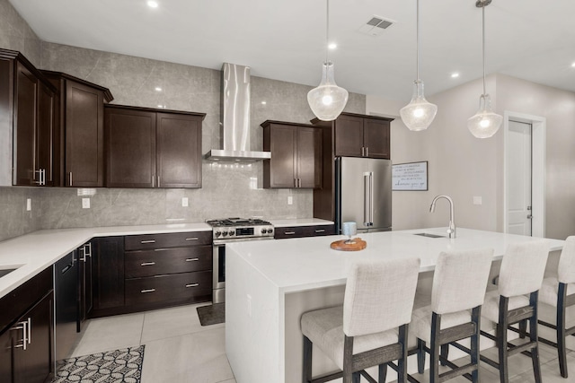 6527 Trestle Glen Rd NW, Albuquerque, NM 87120 - kitchen with wall chimney exhaust hood, stainless steel appliances, a sink, decorative backsplash, and a breakfast bar area