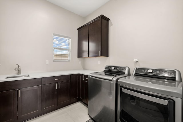 6527 Trestle Glen Rd NW, Albuquerque, NM 87120 - laundry room with cabinet space, separate washer and dryer, and light tile patterned flooring