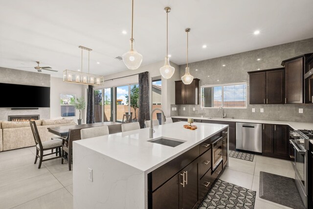 6527 Trestle Glen Rd NW, Albuquerque, NM 87120 - kitchen with stainless steel appliances, a sink, a ceiling fan, light tile patterned floors, and recessed lighting