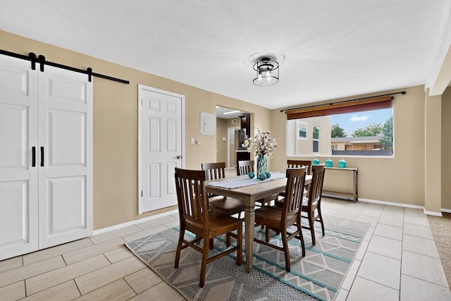3801 Simms Ave SE, Albuquerque, NM 87108 - dining room with a barn door and baseboards
