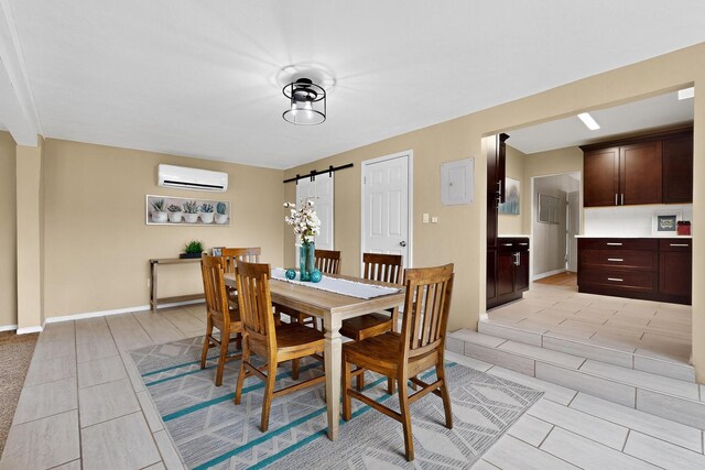 3801 Simms Ave SE, Albuquerque, NM 87108 - dining space with a wall mounted air conditioner, a barn door, and light tile patterned flooring