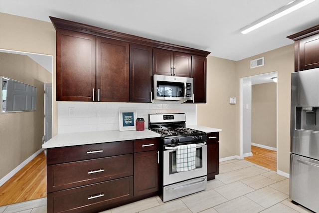 3801 Simms Ave SE, Albuquerque, NM 87108 - kitchen with stainless steel appliances, decorative backsplash, light countertops, dark brown cabinetry, and light tile patterned flooring