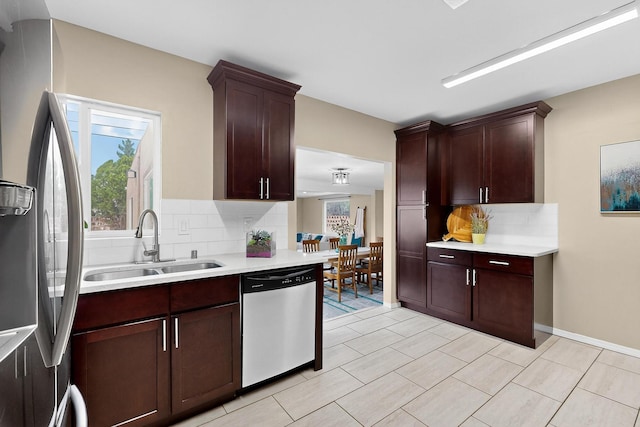 3801 Simms Ave SE, Albuquerque, NM 87108 - kitchen with stainless steel appliances, decorative backsplash, light countertops, and light tile patterned floors