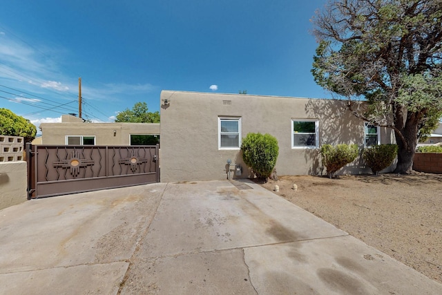 3801 Simms Ave SE, Albuquerque, NM 87108 - view of front of home featuring stucco siding and a gate