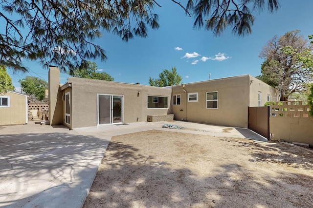 3801 Simms Ave SE, Albuquerque, NM 87108 - back of property with stucco siding and a patio area
