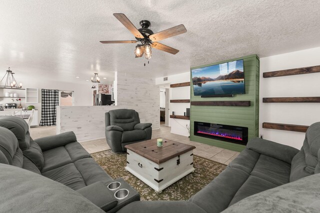 3758 Cattle Dr NE, Rio Rancho, NM 87144 - living room with a chandelier, a textured ceiling, a ceiling fan, tile patterned flooring, and a glass covered fireplace