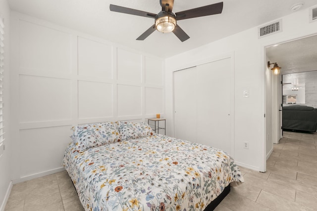 3758 Cattle Dr NE, Rio Rancho, NM 87144 - bedroom featuring a decorative wall, light tile patterned flooring, a closet, and a ceiling fan