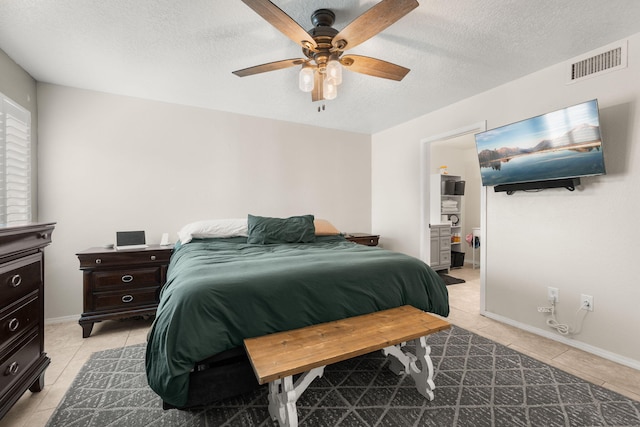 3758 Cattle Dr NE, Rio Rancho, NM 87144 - bedroom featuring light tile patterned floors, a textured ceiling, and a ceiling fan