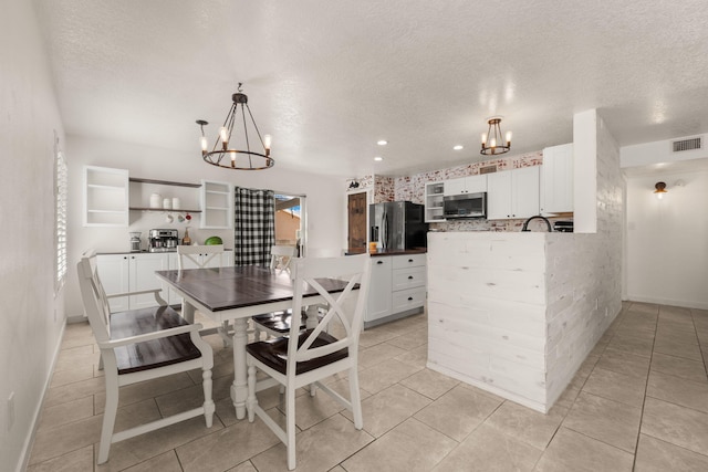 3758 Cattle Dr NE, Rio Rancho, NM 87144 - dining room with a chandelier, a textured ceiling, light tile patterned flooring, and recessed lighting