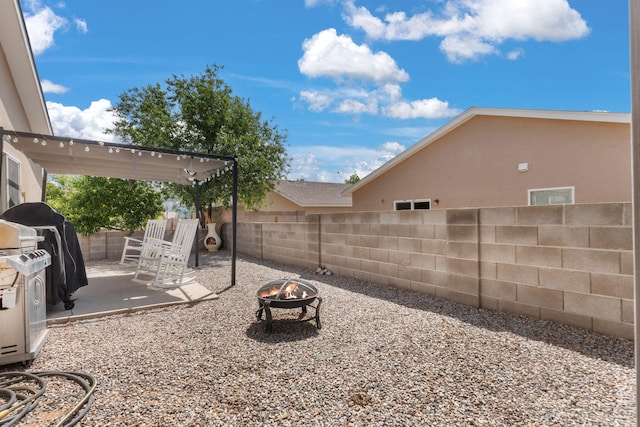 3758 Cattle Dr NE, Rio Rancho, NM 87144 - fenced backyard featuring a fire pit and a patio area