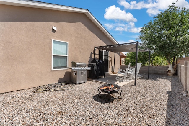 3758 Cattle Dr NE, Rio Rancho, NM 87144 - back of property featuring an outdoor fire pit, stucco siding, a pergola, a patio, and a fenced backyard