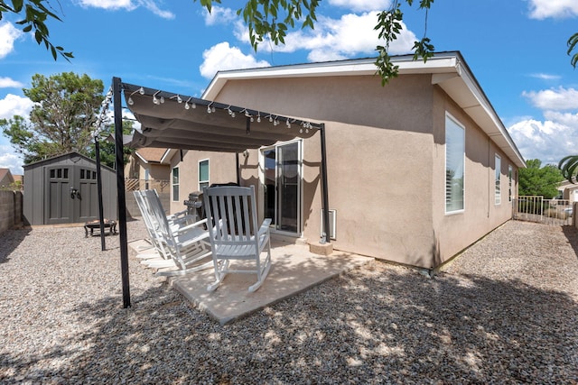 3758 Cattle Dr NE, Rio Rancho, NM 87144 - back of property featuring stucco siding, a storage shed, and a patio area