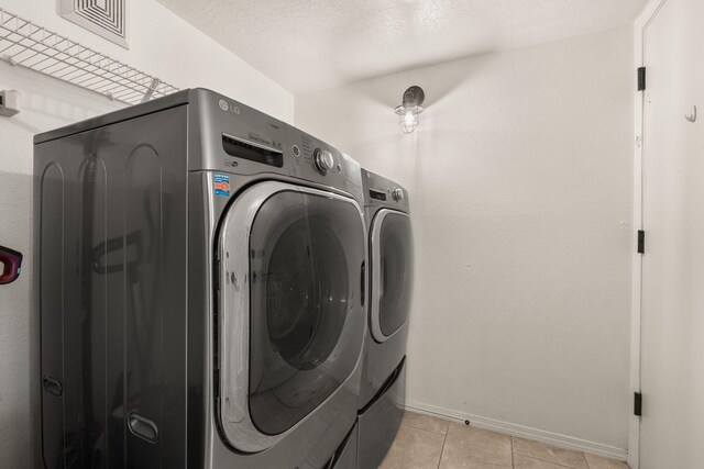 3758 Cattle Dr NE, Rio Rancho, NM 87144 - laundry area with washing machine and clothes dryer and light tile patterned flooring