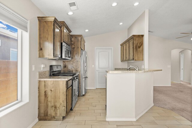 2170 Firewheel Ave SW, Los Lunas, NM 87031 - kitchen featuring stainless steel appliances, arched walkways, a ceiling fan, a peninsula, and recessed lighting