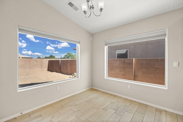 2170 Firewheel Ave SW, Los Lunas, NM 87031 - spare room featuring a chandelier, wood tiled floors, and lofted ceiling