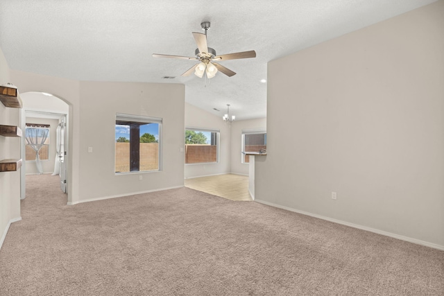 2170 Firewheel Ave SW, Los Lunas, NM 87031 - empty room featuring carpet, a ceiling fan, arched walkways, lofted ceiling, and a textured ceiling