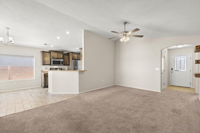 2170 Firewheel Ave SW, Los Lunas, NM 87031 - unfurnished living room featuring light carpet, arched walkways, a textured ceiling, ceiling fan, and recessed lighting