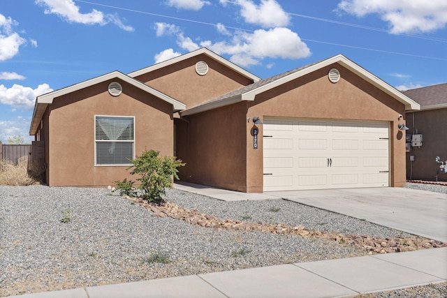 2170 Firewheel Ave SW, Los Lunas, NM 87031 - ranch-style house featuring an attached garage, stucco siding, and concrete driveway
