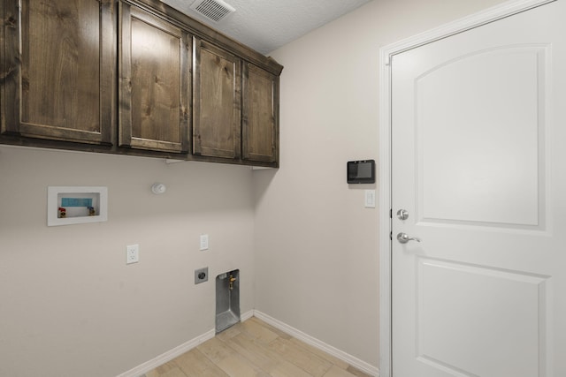 2170 Firewheel Ave SW, Los Lunas, NM 87031 - laundry area featuring washer hookup, electric dryer hookup, cabinet space, light wood finished floors, and hookup for a gas dryer