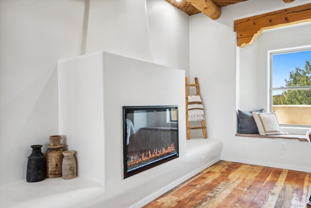 30A Arroyo Coyote Rd, Santa Fe, NM 87508 - detailed view of a glass covered fireplace and wood finished floors