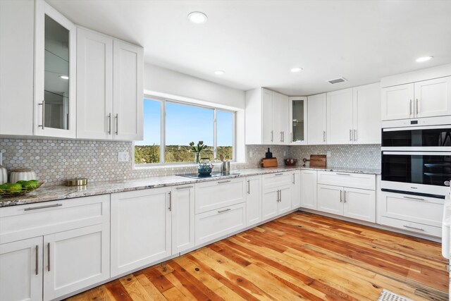 30A Arroyo Coyote Rd, Santa Fe, NM 87508 - kitchen featuring white cabinetry, white double oven, decorative backsplash, and recessed lighting
